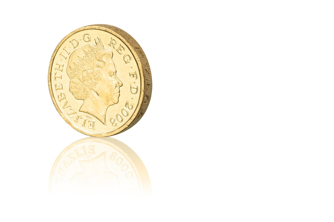 Immagine di una sterlina d'oro con grafico dei valori attuali per vendere o collezionare.